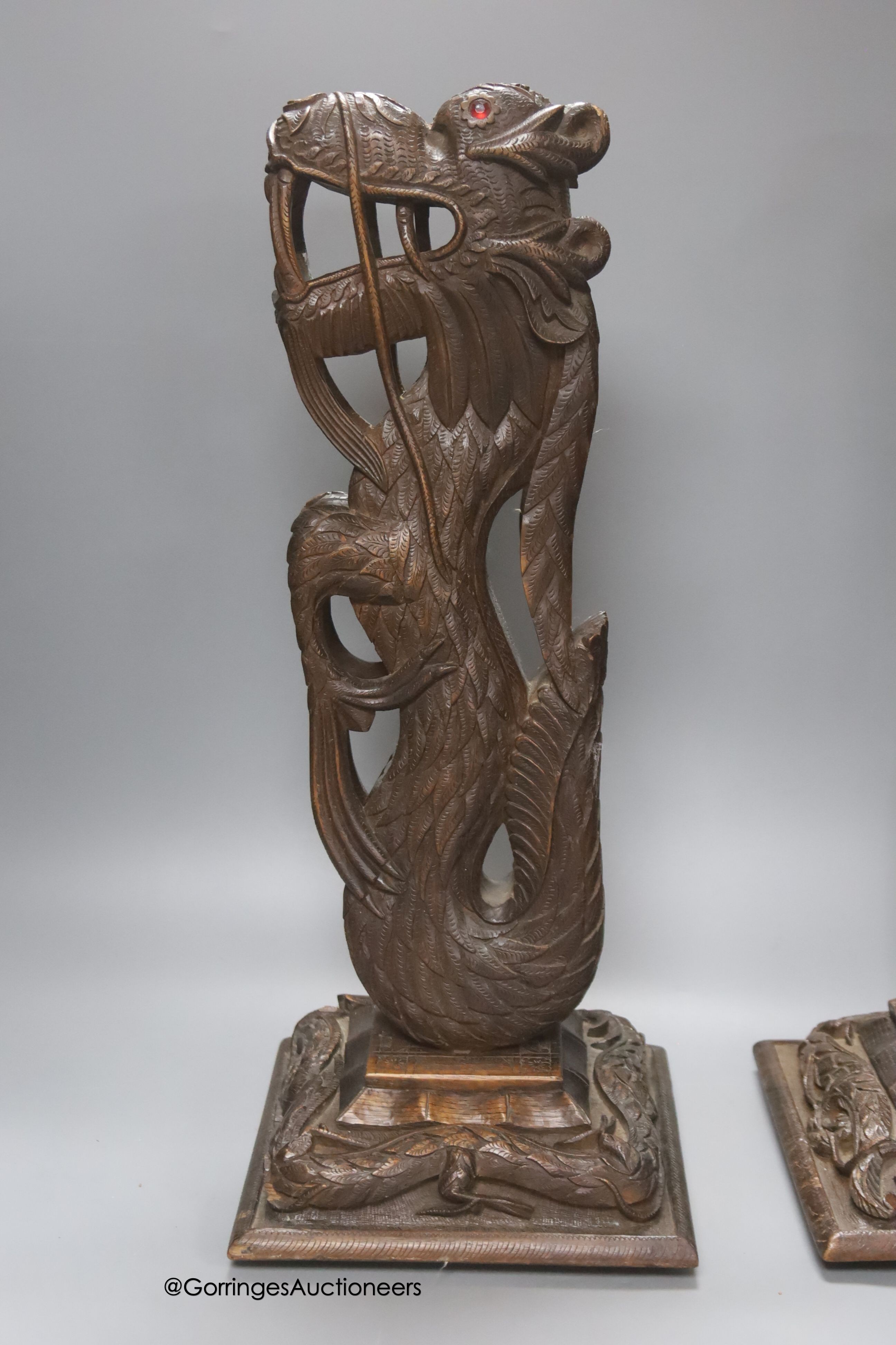 A pair of Burmese carved hardwood 'dragon' lamps, height 50cm, lacking light fittings